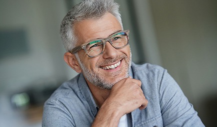 Man smiles with dental implants in Baltimore