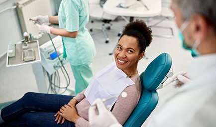 Woman smiling at dentist during exam