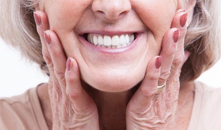 a woman touching her cheeks and smiling