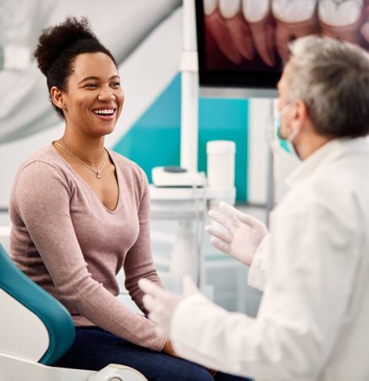 Woman smiling with dentist during her dental checkup and cleaning