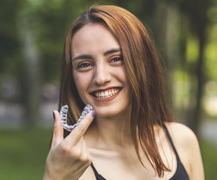 Woman holding Invislaign tray