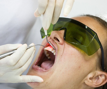 Woman having crown lengthening procedure