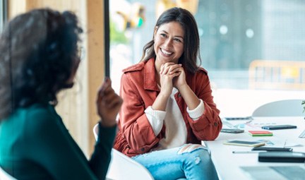 Woman smiling at coworker in office