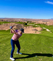 Dr. Charlie Ward playing golf in a desert area