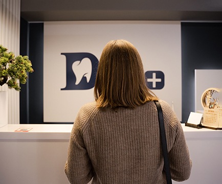 Woman checking in at emergency dentist