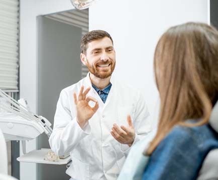 Dentist and patient discussing full mouth reconstruction treatment