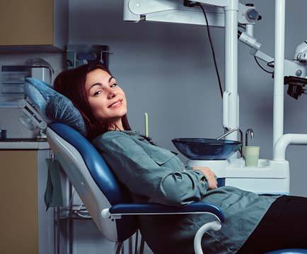 Relaxed dental patient, happy she could afford full mouth reconstruction