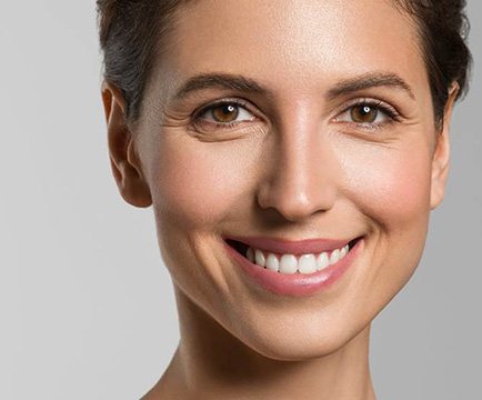 Smiling woman enjoying the benefits of a gum graft in Baltimore