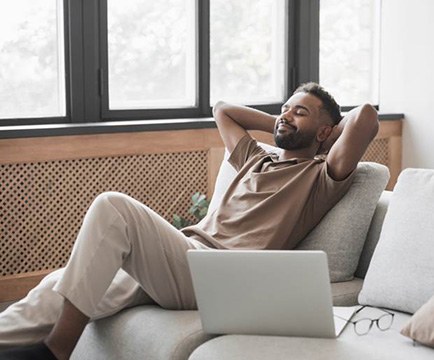 Man relaxing at home while recovering from gum graft surgery