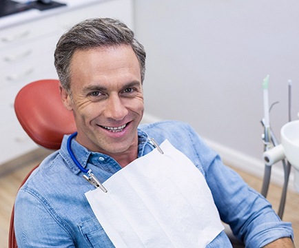 Man seeing implant dentist in Baltimore