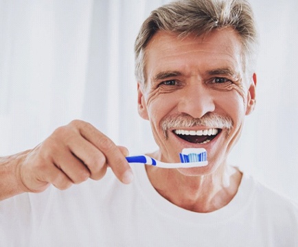 man brushing his teeth