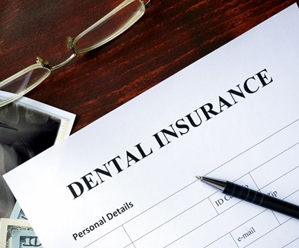 Dental insurance paperwork for the cost of dental implants in Baltimore 