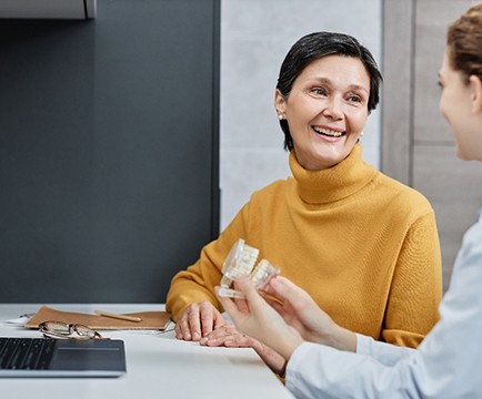 A patient consulting a dentist about implant denture treatment