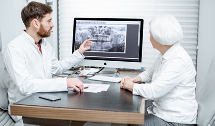 dentist showing a patient their X-rays 