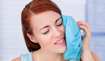 Woman using a cold compress