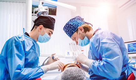 dentists working on patient’s smile 