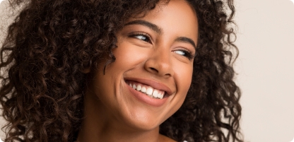 Young woman smiling and looking off into the distance