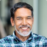 Smiling man wearing blue plaid button down shirt