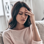 Woman holding her head in pain