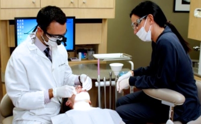 Dentist and dental team member treating patient in Baltimore