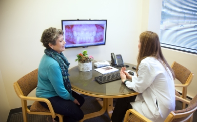 Dentist and patient in consultation room in Baltimore dental office