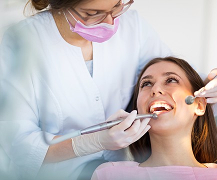 Periodontist examining patient's smile