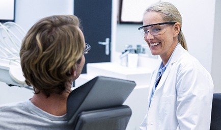 Smiling patient talking to dentist during dental checkup