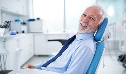 Senior man smiling while relaxing in treatment chair