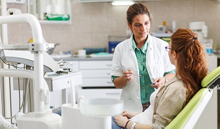 A dentist talking with her patient