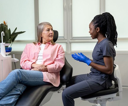 Patient and dental team member having serious conversation