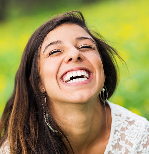 Woman with healthy teeth and gums after periodontal therpay