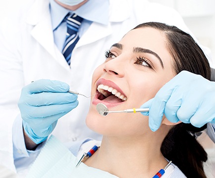 Woman receiving oral cancer screening