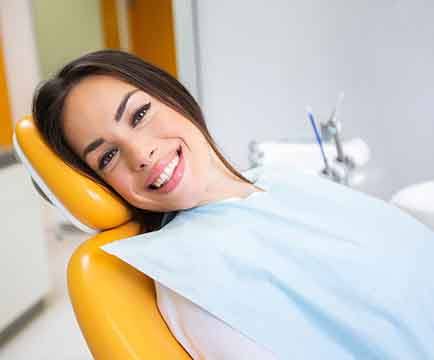 Woman figuring the cost of root canal treatment in Baltimore