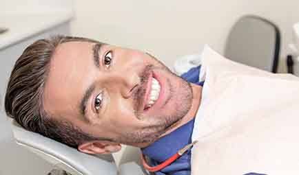 Patient and dentist discussing payment for root canal