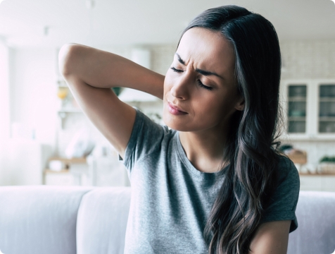Woman in need of T M J therapy experiencing neck pain