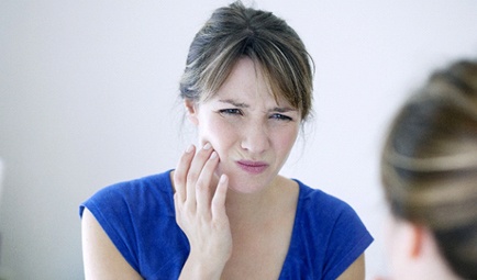 Woman with toothache from Bruxism in Baltimore