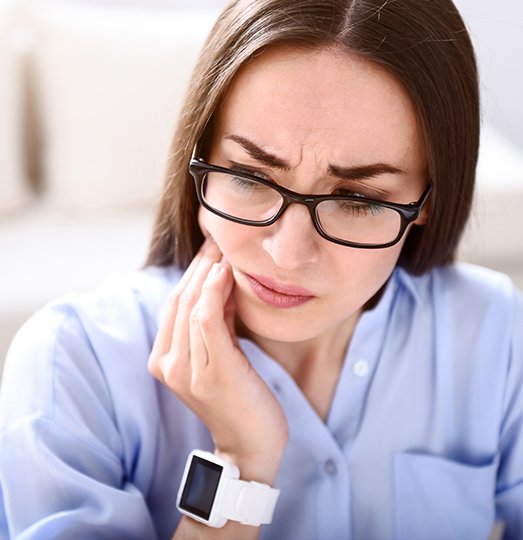 Woman with jaw pain prior to T M J therapy