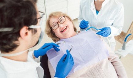 Woman smiling at cosmetic dentist during consultation