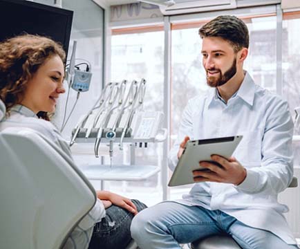 Woman at dentist for teeth whitening in Baltimore