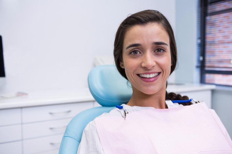 Female patient smiling after a full mouth reconstruction