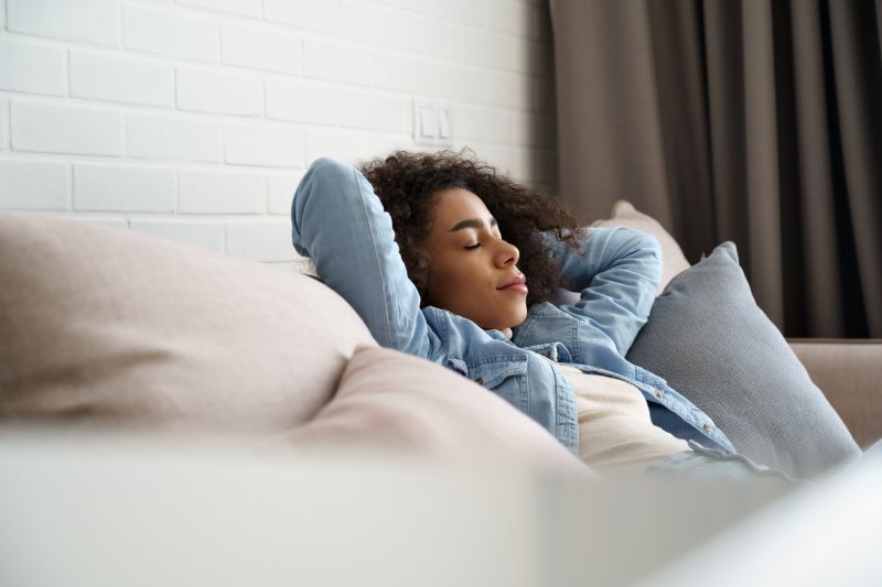 Woman resting at home while recovering from full mouth reconstruction