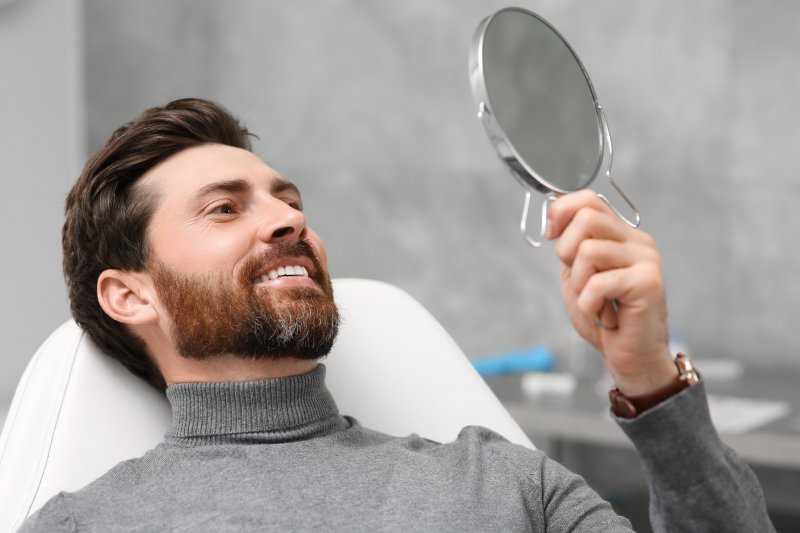 Patient looking at their new cosmetic dentistry