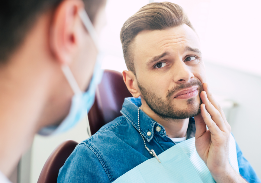 Man holding jaw in pain