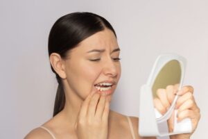 Woman looking at her red gums
